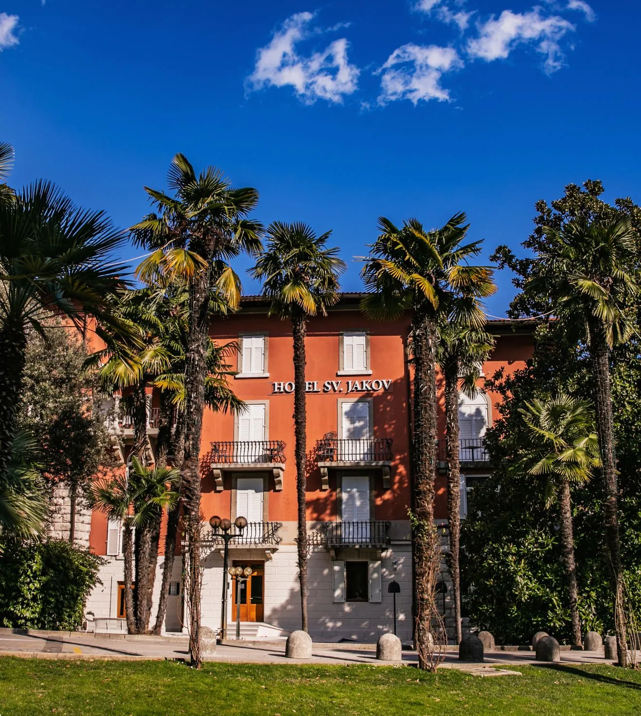 Historic Hotel Sveti Jakov in Opatija surrounded by lush palm trees